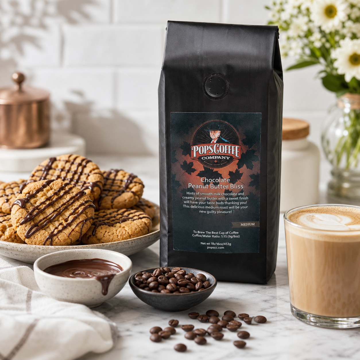 Chocolate Peanut Butter Bliss lifestyle image 3: coffee bag beside peanut butter cookies, chocolate drizzle, coffee beans, and latte