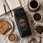 Chocolate Peanut Butter Bliss lifestyle image 4: coffee bag in a breakfast flat lay with coffee, toast, chocolate, and notebook