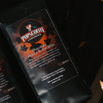 Pops Chocolate Peanut Butter Bliss bag on a wooden bench with fall leaves