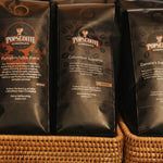 Pops Columbian Supremo bags in a woven basket at a cafe