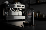 Pops Coffee Company Espresso Roast bag on a dark espresso bar with perfect double espresso shot and gleaming machine