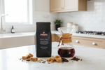 Pops Coffee Company Kenya AA Tembo bag on white marble with Chemex pour-over and toffee and chocolate pieces