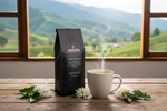 Pops Coffee Company Columbian Supremo bag on a rustic table with Colombian mountain landscape through window