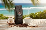 Pops Coffee Company Toasted Coconut bag on a tropical beach table with steaming coffee and fresh coconut