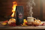 Pops Coffee Company Pumpkin Spice Blend bag on a wooden table with autumn leaves, small pumpkins and steaming mug