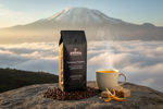 Pops Coffee Company Tanzanian Peaberry bag on stone with Mount Kilimanjaro in the background and toffee and citrus