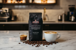 Pops Coffee Company Daniela's Espresso Blend bag on a marble cafe counter with espresso shot and latte art