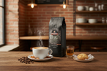 Pops Coffee Company Amaretti Cookie bag on a cafe table with cappuccino, amaretto liqueur and whole almonds