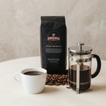 Sumatra Mandheling coffee bag with a cup of black coffee and a French press.