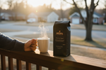 Pops Coffee Company Pops House Blend bag on a front porch railing at sunrise with steaming mug of coffee