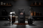 Pops Coffee Company French Roast bag on dark marble with steaming dark coffee and French press full of bold dark brew